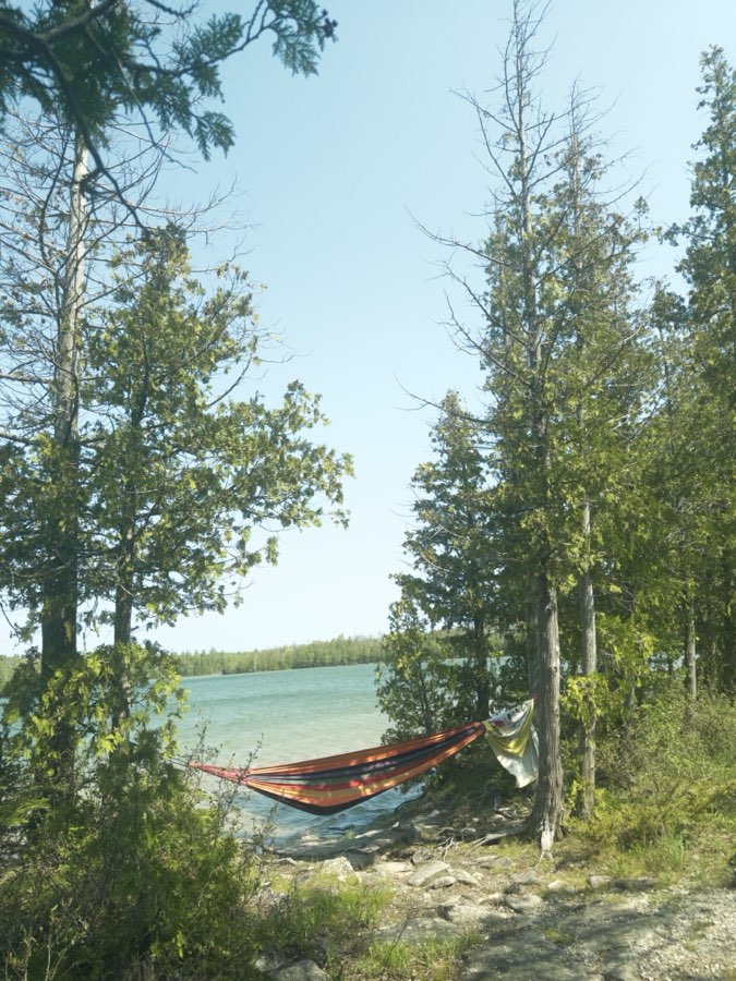 Our hammock strung between trees over the water at Bruce Peninsula