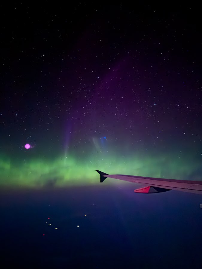 Aurora seen from a plane window over Alberta