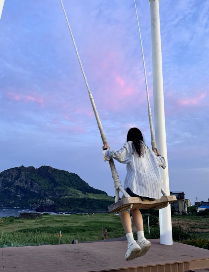 On a swing looking out at Udo Island, Jeju