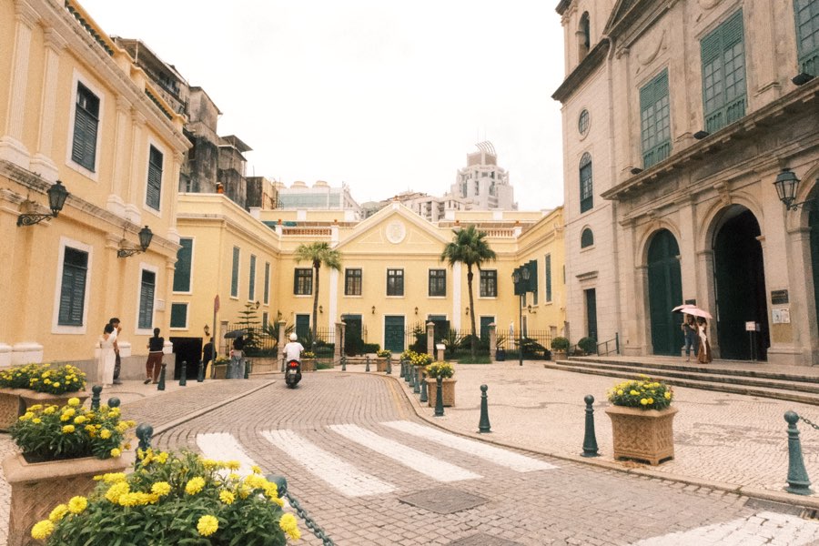 Cobblestone street with yellow colonial buildings in Macau