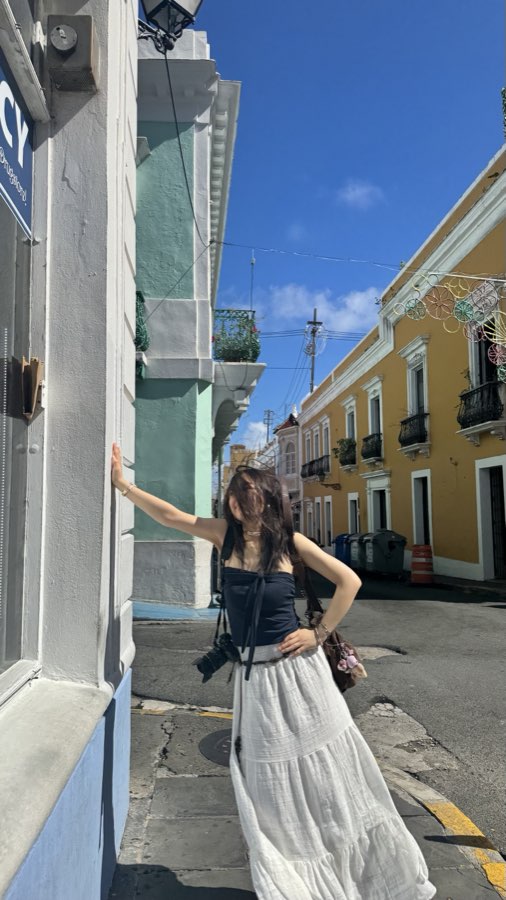 Posing on a colorful street in Puerto Rico with a camera